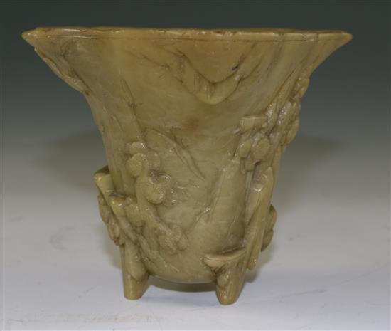 A Chinese pale green soapstone libation cup, 19th century, width 18.5cm, height 10cm, faults